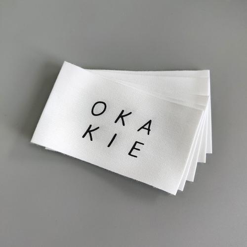  friendly White Cotton Woven Labels with Folded Edges and Black Logos - Ideal Clothing Accessories